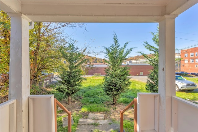 view of yard featuring covered porch