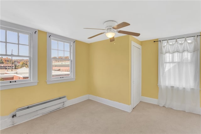 carpeted empty room featuring a baseboard radiator and ceiling fan