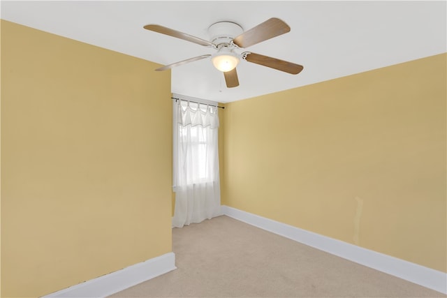 spare room with light carpet and ceiling fan