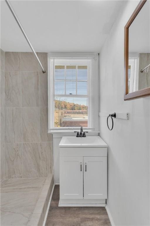 563 Coleman Ave, Greater Johnstown School District, PA 15902 - bathroom with a tile shower, wood finished floors, and vanity