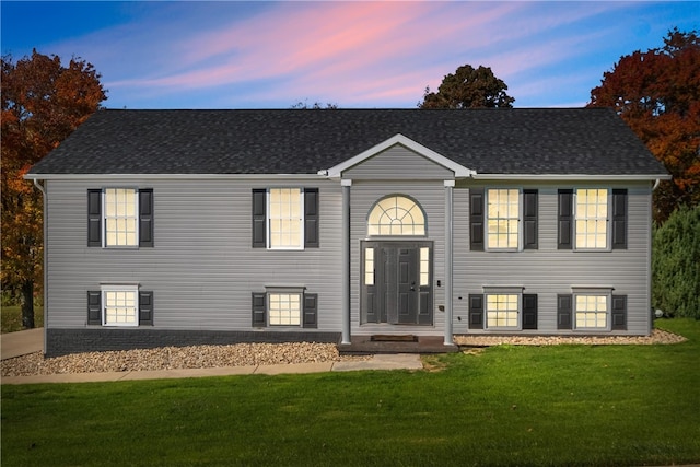 split foyer home featuring a lawn