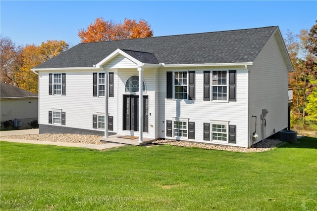 view of front of home featuring a front yard and cooling unit