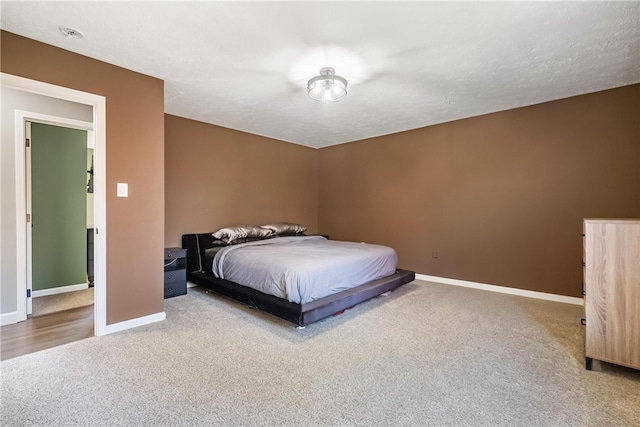 carpeted bedroom with a textured ceiling