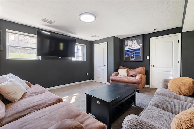 living room featuring a textured ceiling and dark colored carpet