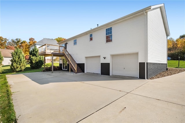 back of house featuring a garage and a deck