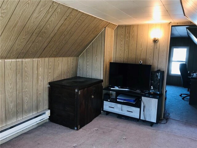 bonus room featuring vaulted ceiling, wood walls, a baseboard heating unit, and light colored carpet