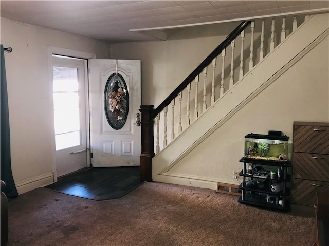 view of carpeted foyer entrance