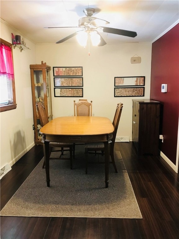 dining area with ceiling fan, ornamental molding, and dark hardwood / wood-style flooring