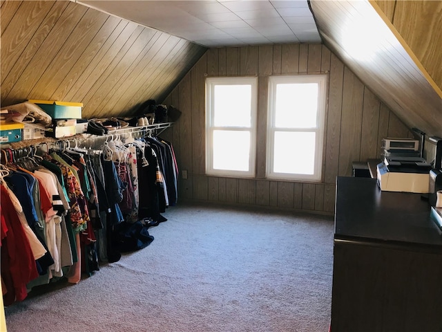 walk in closet featuring carpet and lofted ceiling