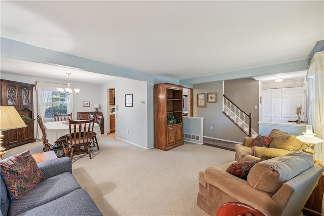 carpeted living room with a notable chandelier