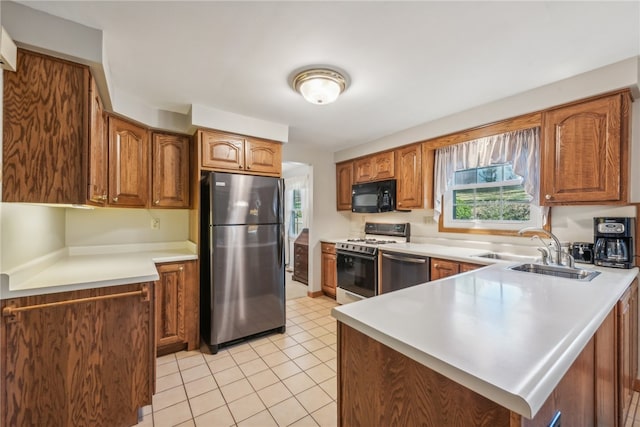 kitchen featuring sink, appliances with stainless steel finishes, and light tile patterned floors