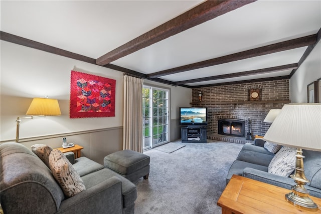 carpeted living room featuring beamed ceiling and a brick fireplace