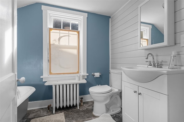 bathroom featuring vanity, vaulted ceiling, toilet, and radiator