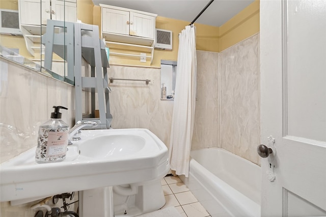 bathroom featuring tile patterned floors, shower / bath combination with curtain, and a wall unit AC