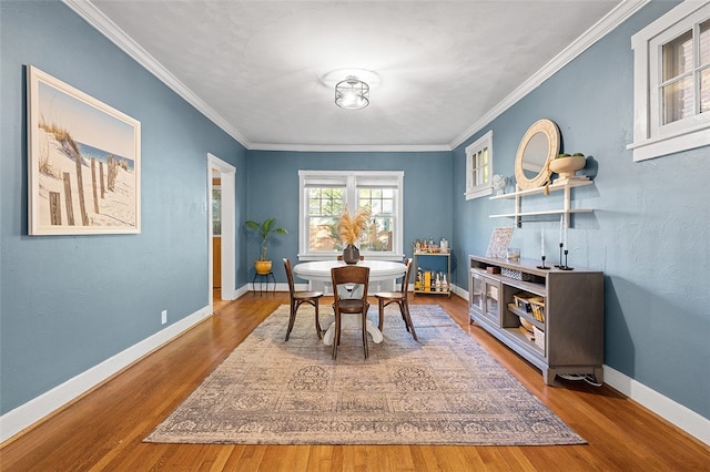 dining space featuring crown molding and wood-type flooring