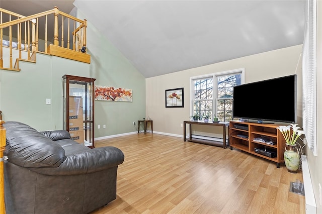 living room with hardwood / wood-style floors and high vaulted ceiling