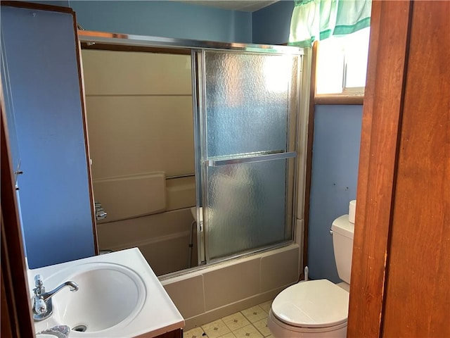 full bathroom with vanity, toilet, and enclosed tub / shower combo