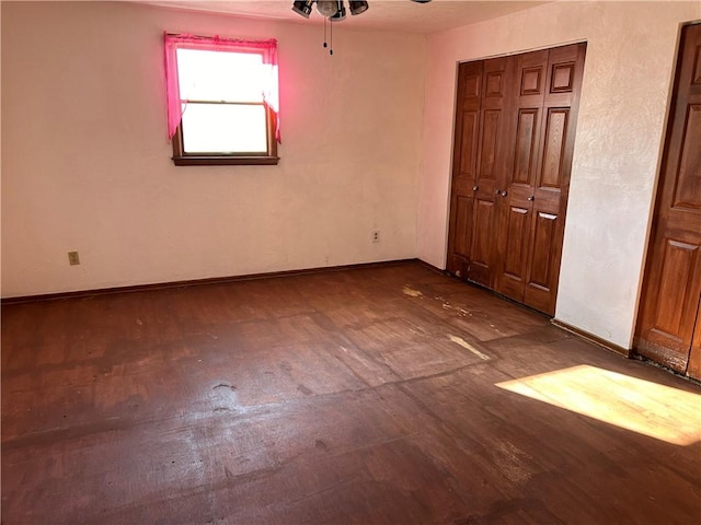 unfurnished bedroom featuring wood-type flooring, a closet, and ceiling fan