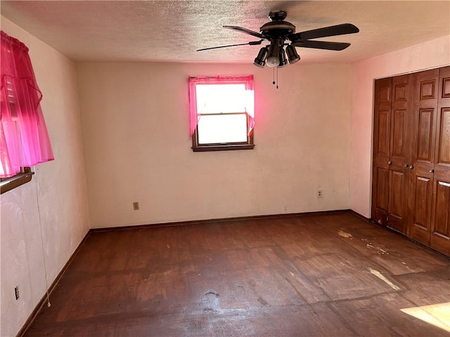 unfurnished bedroom with wood-type flooring, a textured ceiling, a closet, and ceiling fan