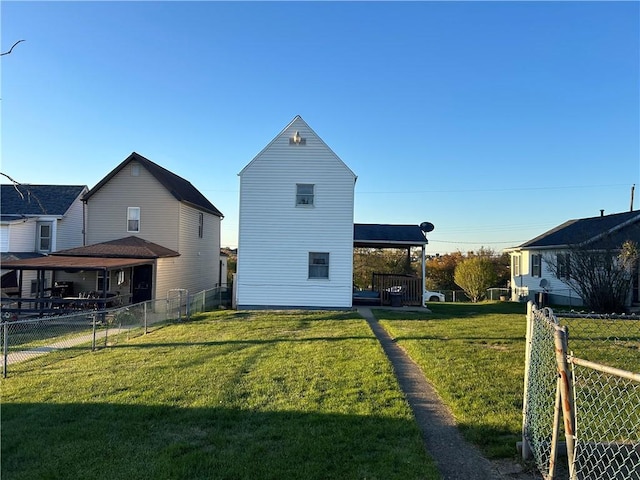 back of house with a lawn