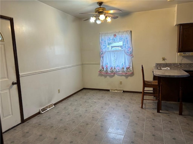 unfurnished dining area featuring ceiling fan