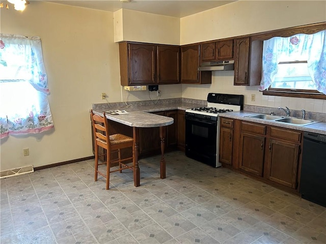 kitchen featuring white gas stove, sink, dark brown cabinetry, and black dishwasher