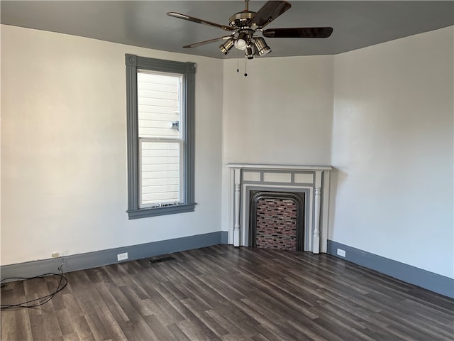 unfurnished living room featuring ceiling fan and dark hardwood / wood-style flooring