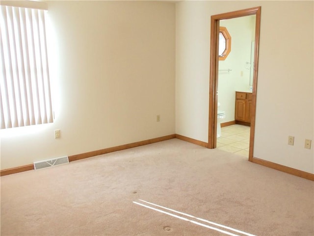 unfurnished room featuring light colored carpet