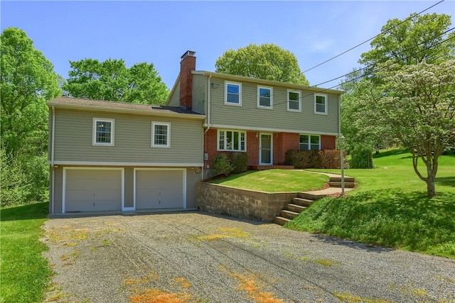 view of front of house featuring a front yard and a garage