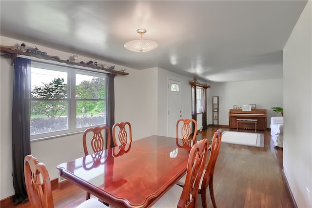 dining space with wood-type flooring