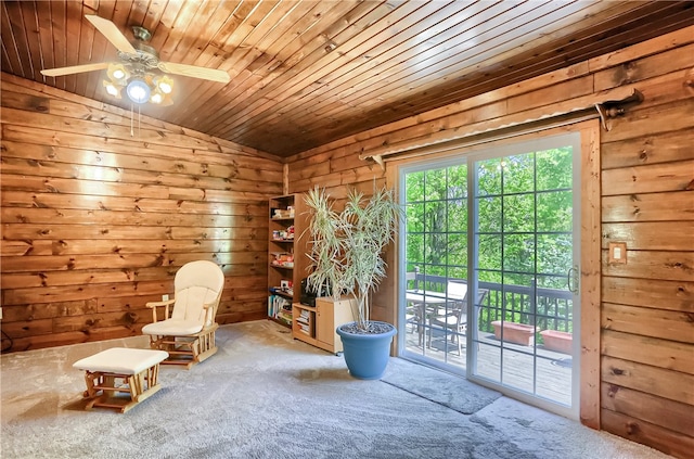 unfurnished room with wood walls, carpet floors, ceiling fan, wooden ceiling, and lofted ceiling