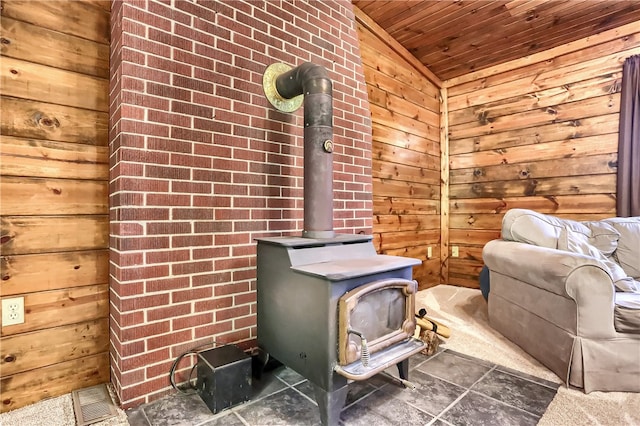 room details with a wood stove, wooden walls, and wooden ceiling