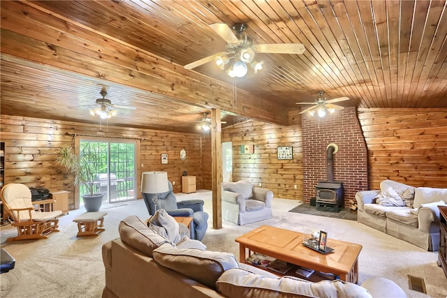 carpeted living room featuring a wood stove, wooden walls, wooden ceiling, and lofted ceiling