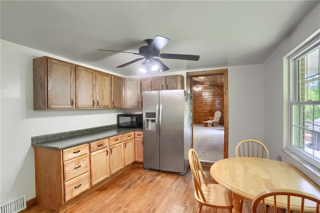 kitchen featuring ceiling fan, light wood-type flooring, and stainless steel fridge