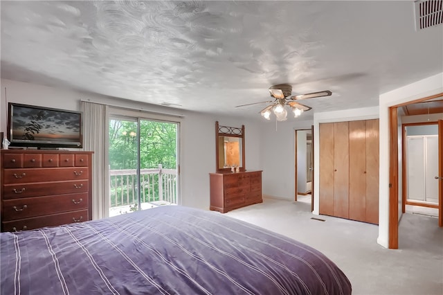 unfurnished bedroom featuring access to exterior, light colored carpet, and ceiling fan