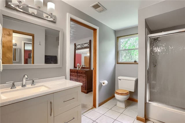 full bathroom featuring vanity, enclosed tub / shower combo, toilet, and tile patterned floors