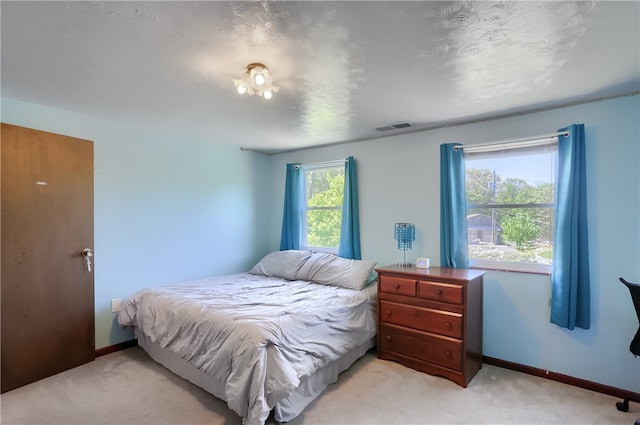 carpeted bedroom with a textured ceiling