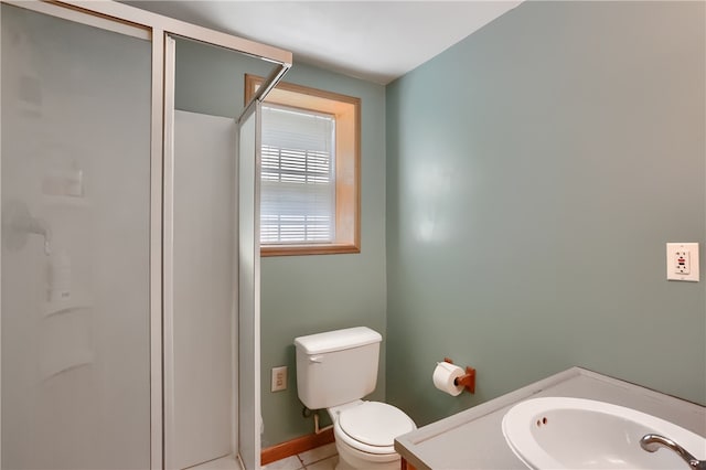 bathroom with vanity, toilet, and tile patterned floors