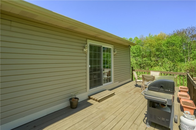 wooden deck featuring a grill