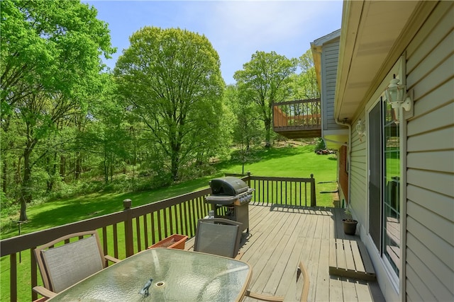 wooden terrace featuring a yard