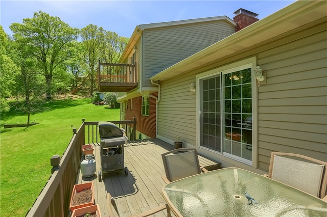 wooden deck featuring a yard and area for grilling