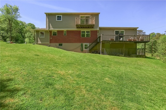 rear view of house with a deck and a lawn