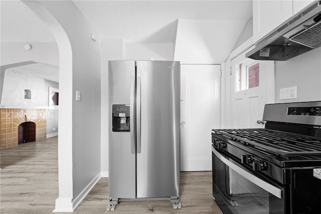 kitchen with light wood-type flooring, black gas range, white cabinets, stainless steel fridge with ice dispenser, and ventilation hood