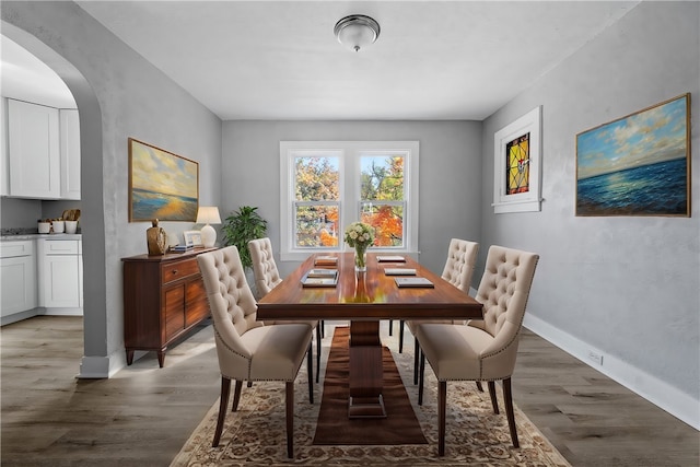 dining space with dark wood-type flooring