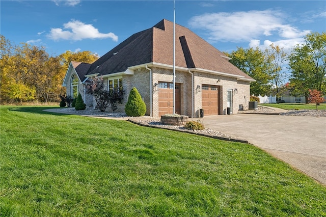 view of side of home with a yard, cooling unit, and a garage