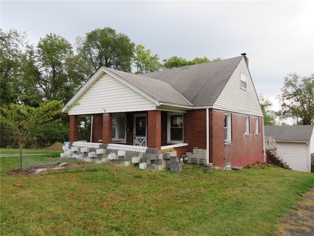 view of front of house with a front yard and covered porch