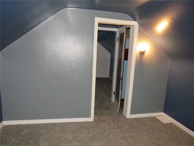 bonus room with carpet flooring and lofted ceiling