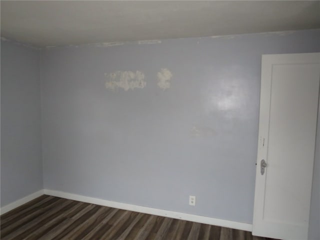 unfurnished room featuring dark hardwood / wood-style floors