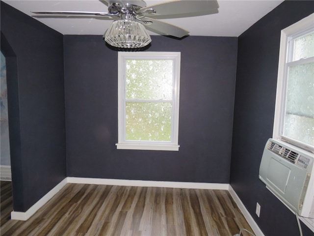 empty room with ceiling fan, cooling unit, and dark hardwood / wood-style flooring