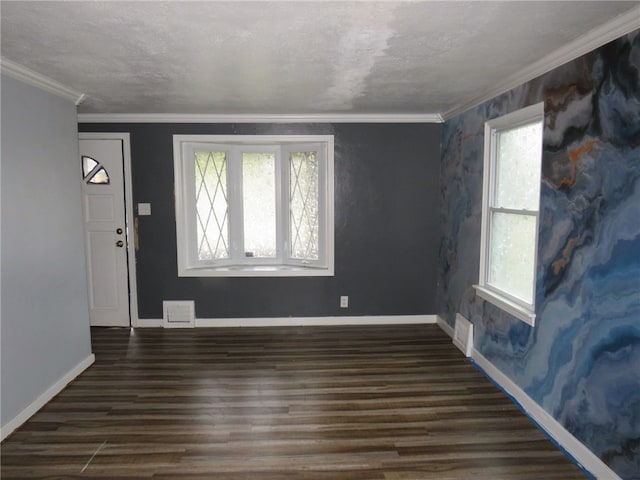 entryway featuring crown molding, dark hardwood / wood-style floors, and a textured ceiling